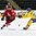 GRAND FORKS, NORTH DAKOTA - APRIL 18: Switzerland's Tobias Greisser #20 dumps the puck into the Sweden zone while Linus Lindstrom #28 defends during preliminary round action at the 2016 IIHF Ice Hockey U18 World Championship. (Photo by Minas Panagiotakis/HHOF-IIHF Images)

